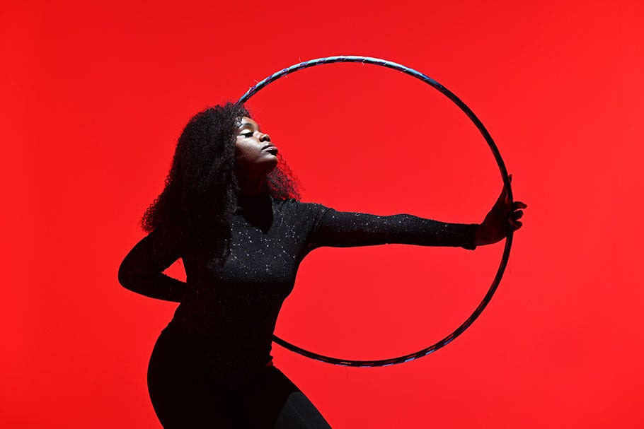 Female Hoop Dancer against Red Background | Nikon Cameras, Lenses & Accessories